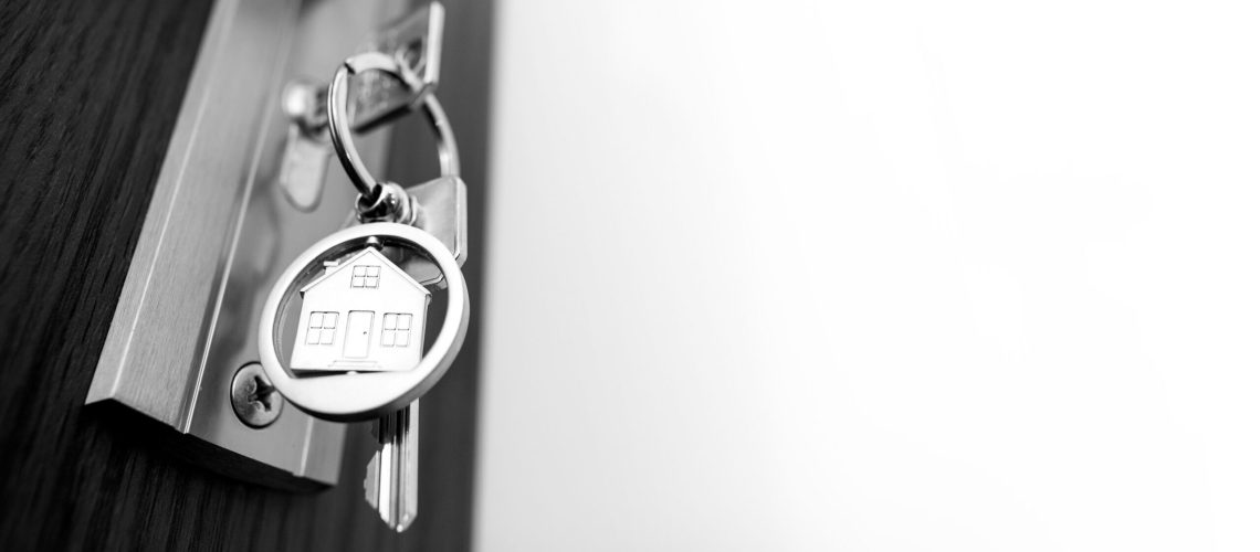 Keys to the apartment in the door. Real estate, mortgage apartment.